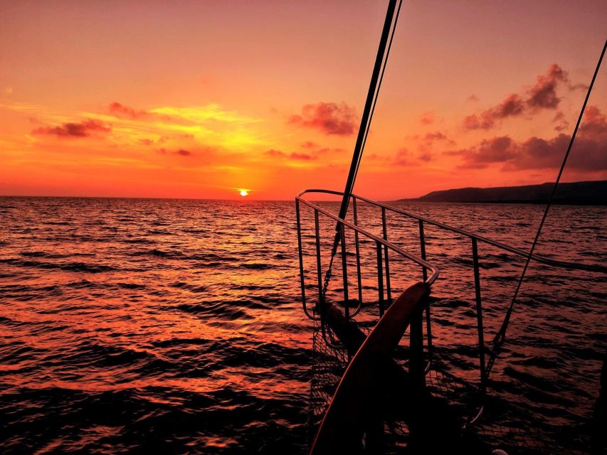 Argostoli: Sunset Cruise with Swim Stops, Dinner, and Wine - Xi Beach swim stop: red-brick sand and real time in the water