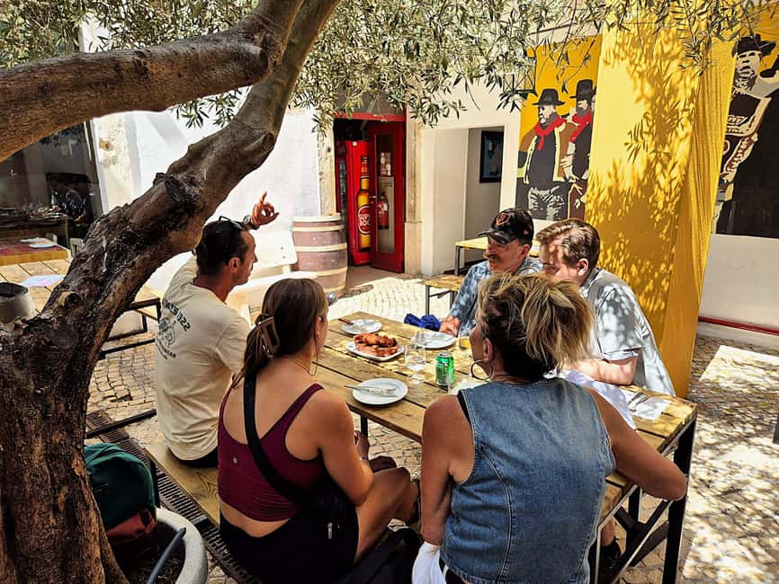 Lisbon Small-Group Food & Wine Tour Eat & Drink like a Local - Chouriço assado with red wine: where the menu gets smoky and real