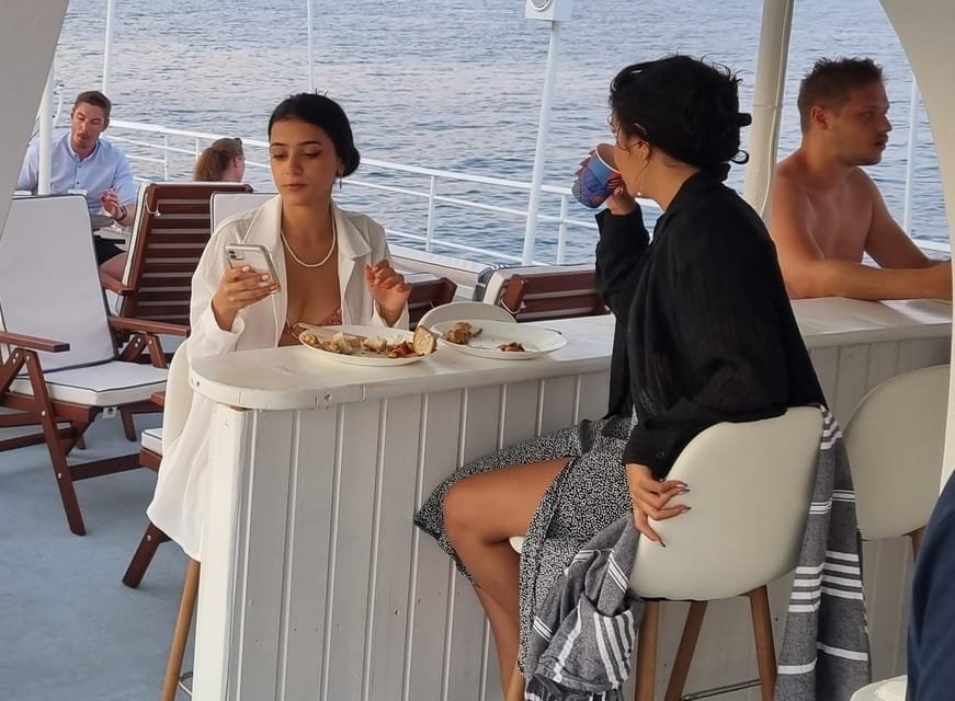 Rhodes: Sunset Cruise with Live Music, Wine & Greek Buffet - From Mandraki Port to the sea: what the cruise feels like