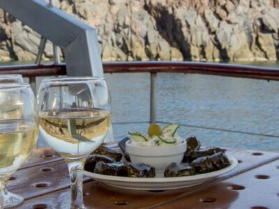 Santorini: Traditional Wooden Boat Tour with Meal and Wine - Getting There: Hotel Pickup and the Van to Vlychada